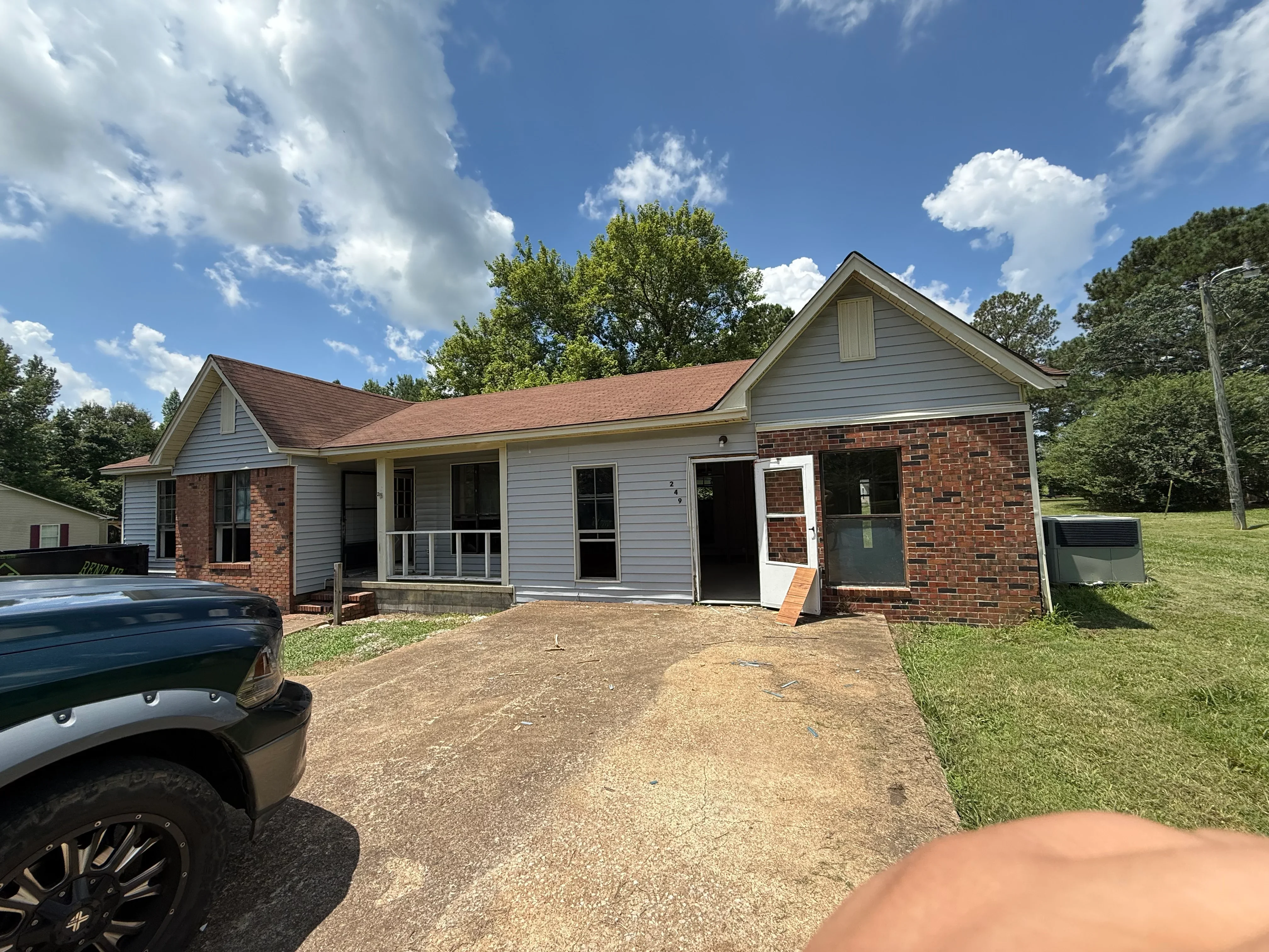Brick and vinyl siding home with new roof, screened porch, and updated exterior finishes