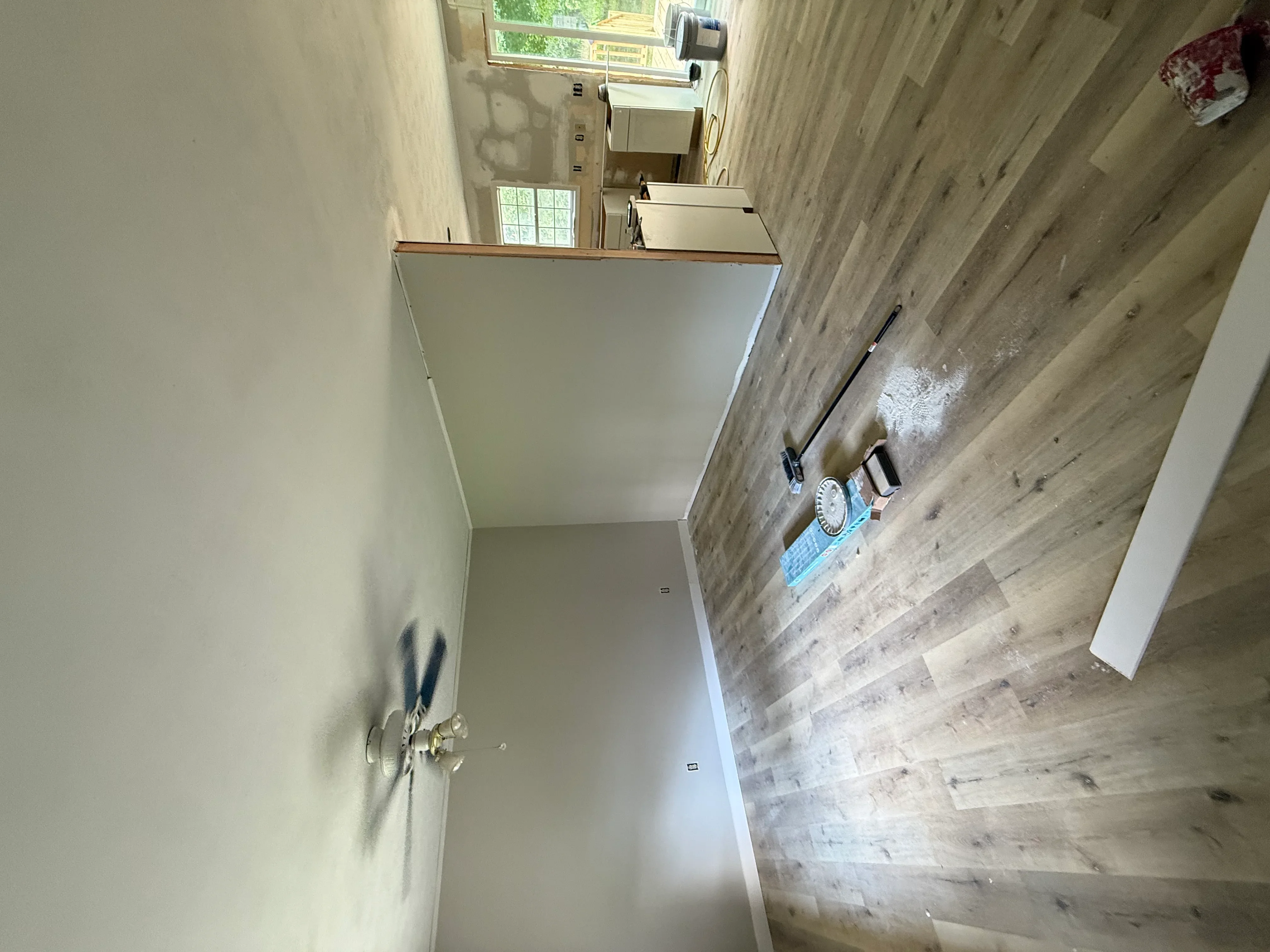 Bathroom with luxury vinyl plank flooring, painted drywall, and new vanity installation