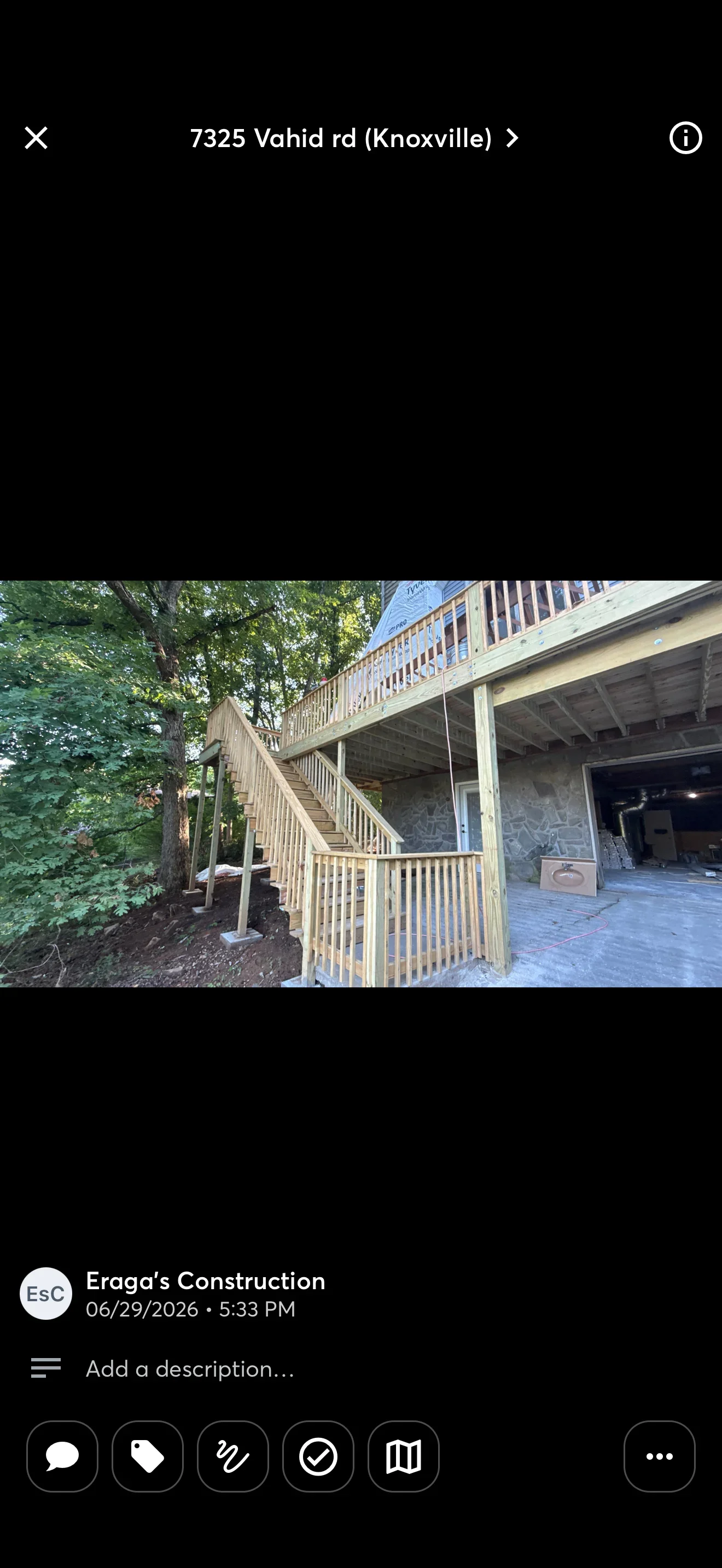Pressure-treated wood deck with stairs, railings, and brick paver patio beneath mature trees