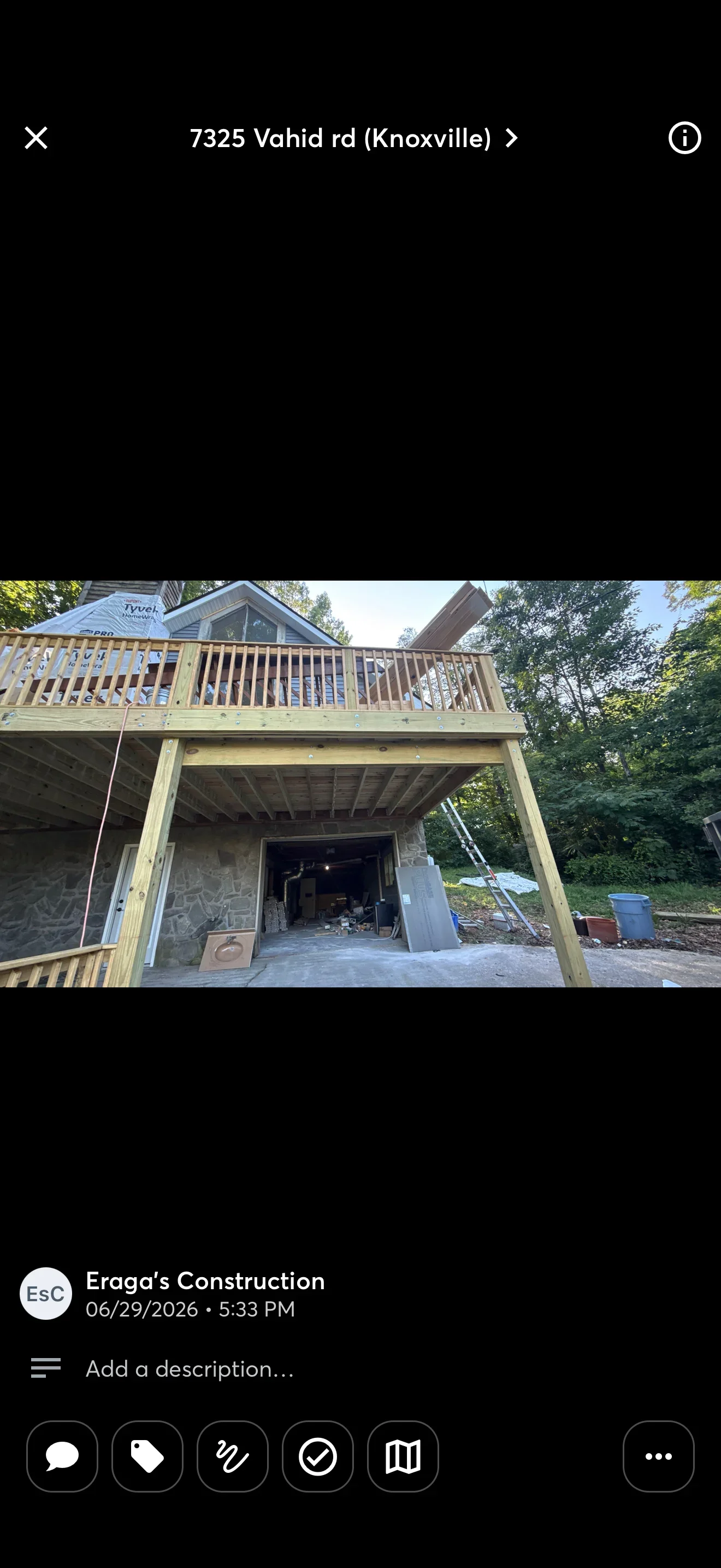 Second story pressure-treated wood deck with railings and covered patio structure below